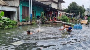 Banjir Pegangsaan Dua Jakarta Utara: Anak-anak Bermain Air, Warga Cuci Peralatan di Tengah Genangan