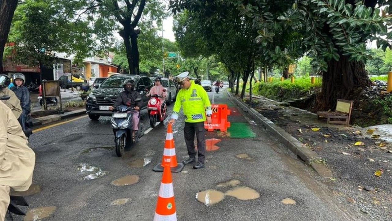 Jalan Juanda Depok Berlubang Parah, Pengendara Motor Berjatuhan, Polisi Pasang Peringatan