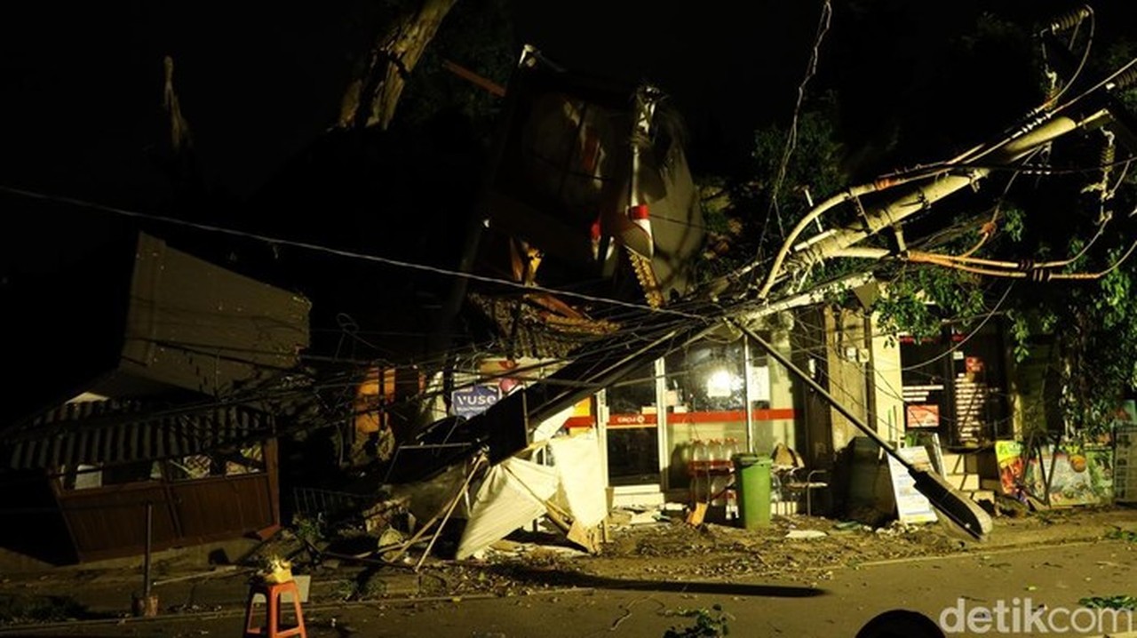 Foto: Kondisi Bangunan Swalayan Dan Tiang Listrik Yang Tertimpa Pohon Tumbang Di Puri Kantor, Jalan Suweta, Ubud, Gianyar, Minggu (15/2/2026). (foto: aryo Mahendro/detikbali)